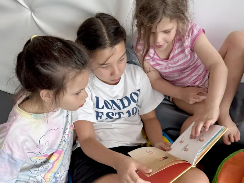 Image of students reading at Equinox's kids holiday camp