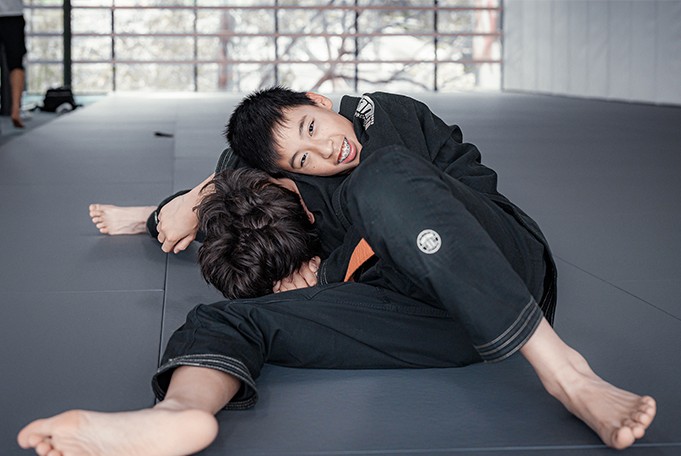 Equinox Academy's teenage students learning essential Brazilian Jiu-Jitsu (BJJ) techniques