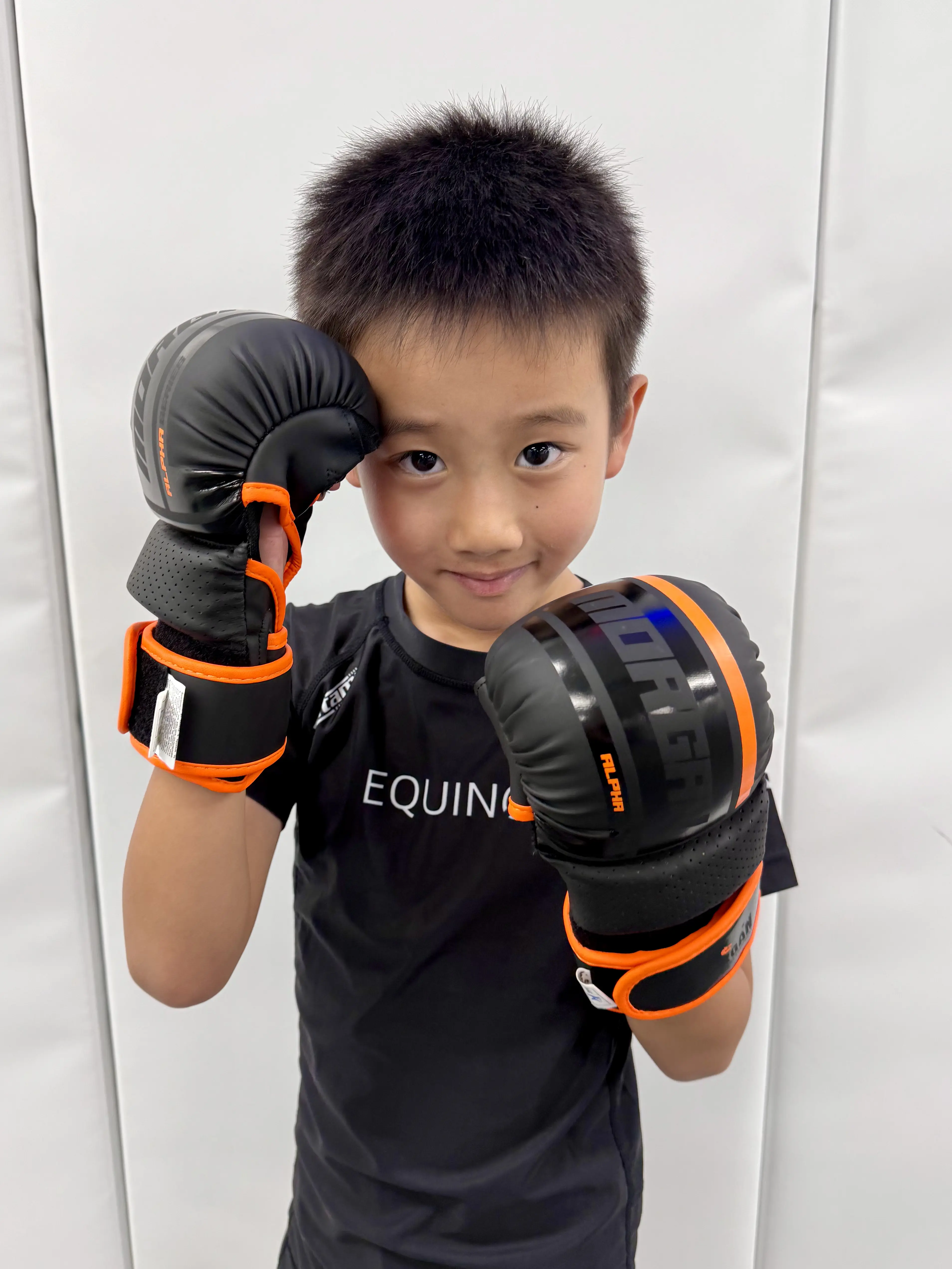 Young student preparing for Equinox Academy's kids Mixed Martial Arts (MMA) class